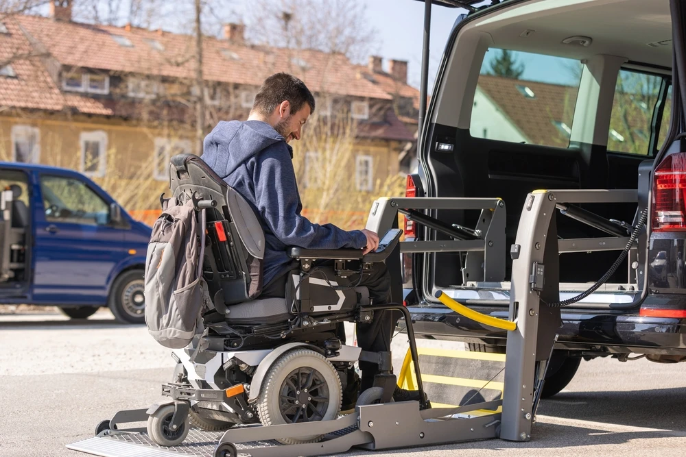 disabled guy on wheelchair getting on a special designed van