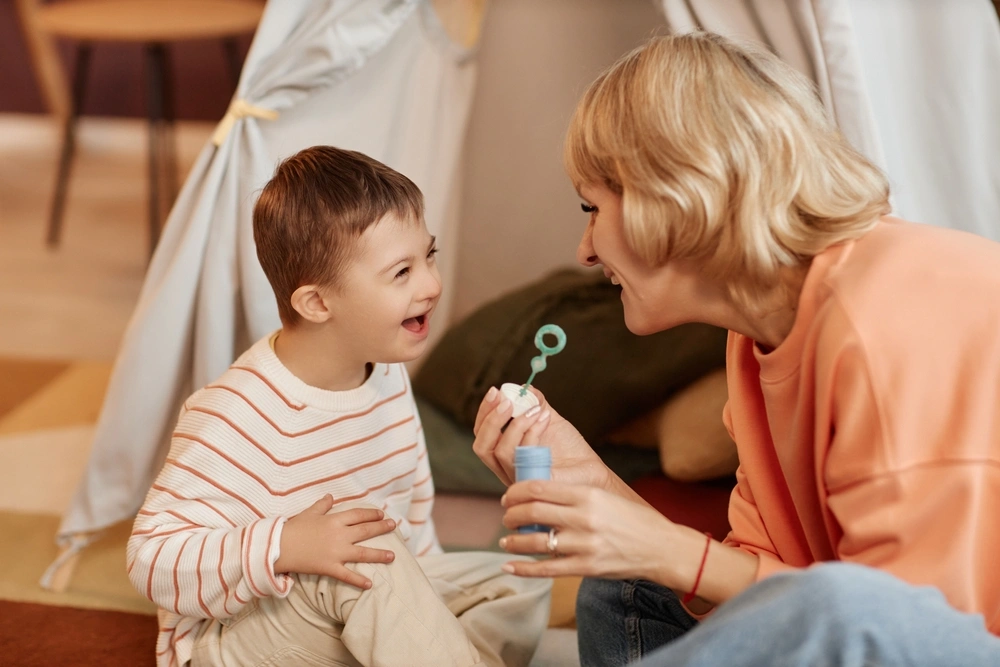 mother playing with disabled young son