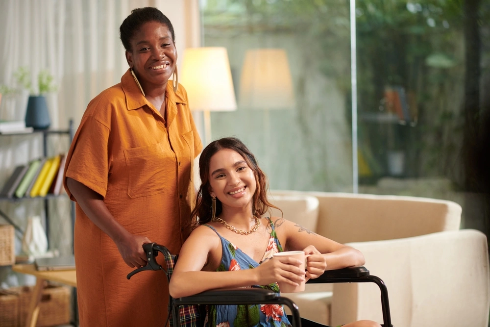 portrait of carer carrying a disabled women on wheelchair, in disability support centre