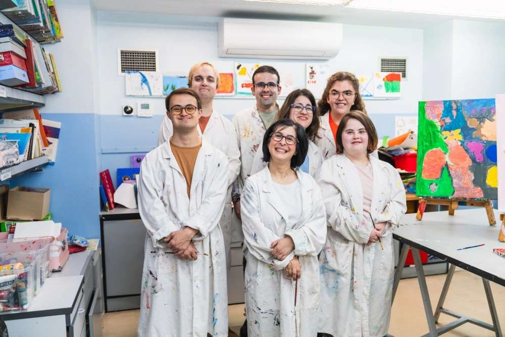 group of disabled friends in a support centre, in a painting class