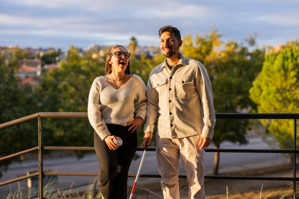 disabled men with carer hanging out in a park